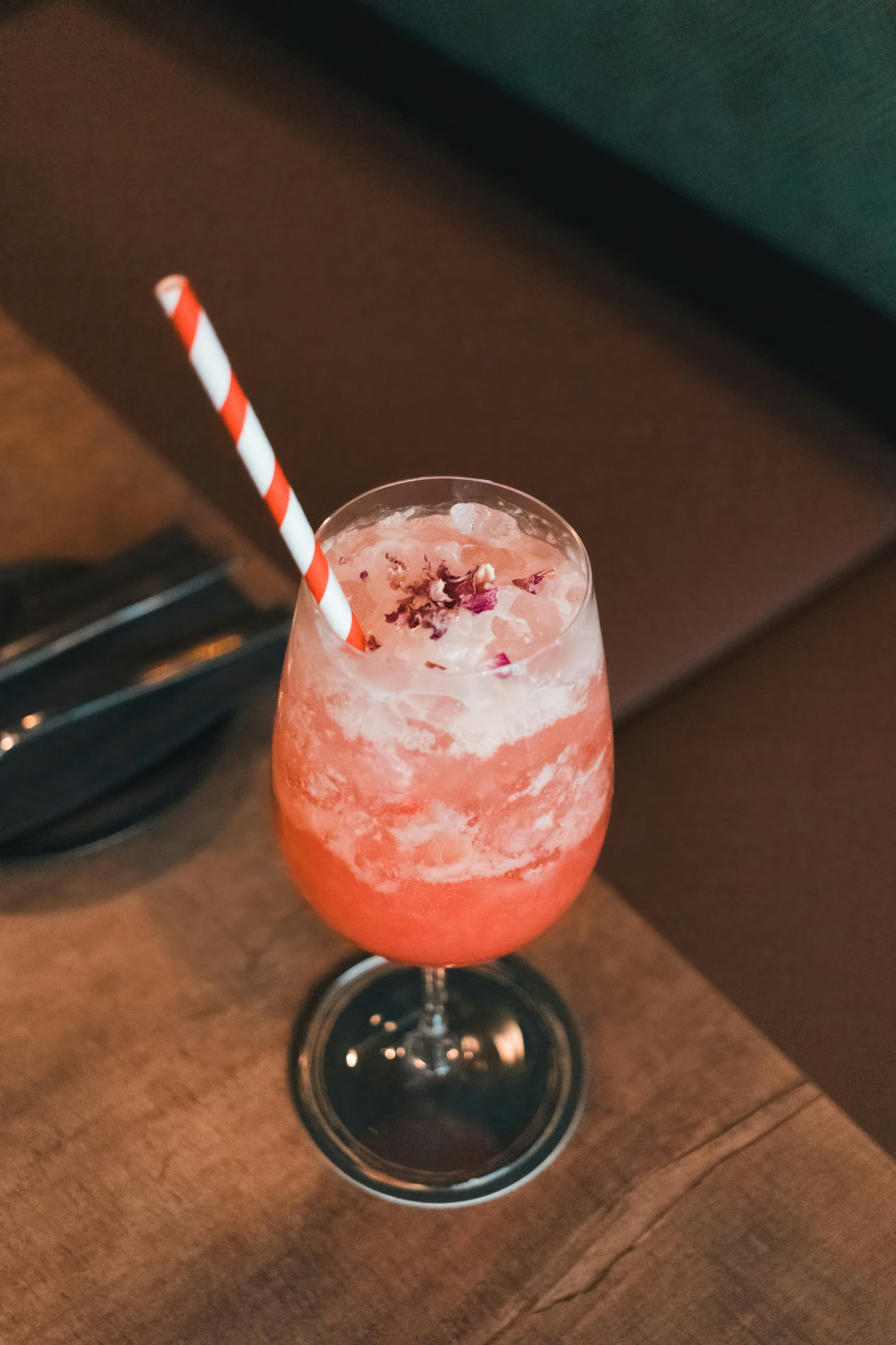 A drink with a striped straw sitting on a table