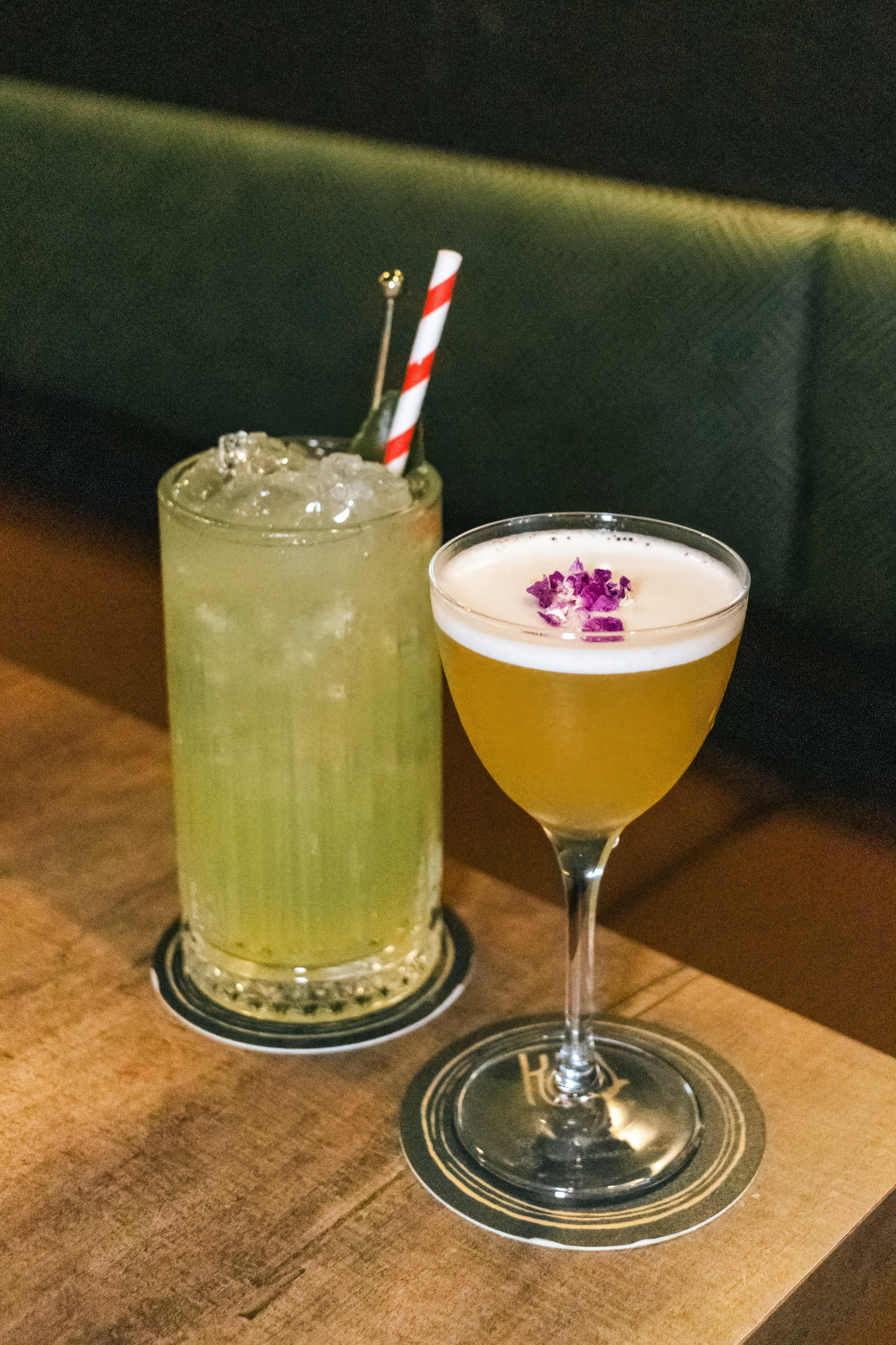 A couple of drinks sitting on top of a wooden table