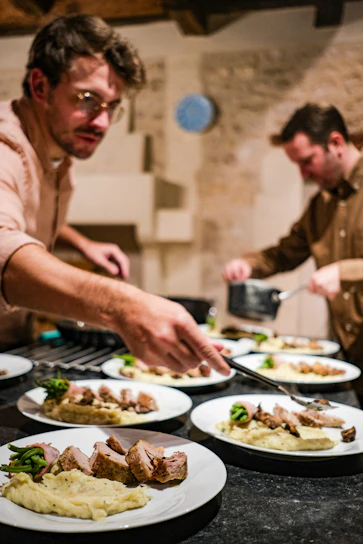 A group of men in a kitchen preparing food