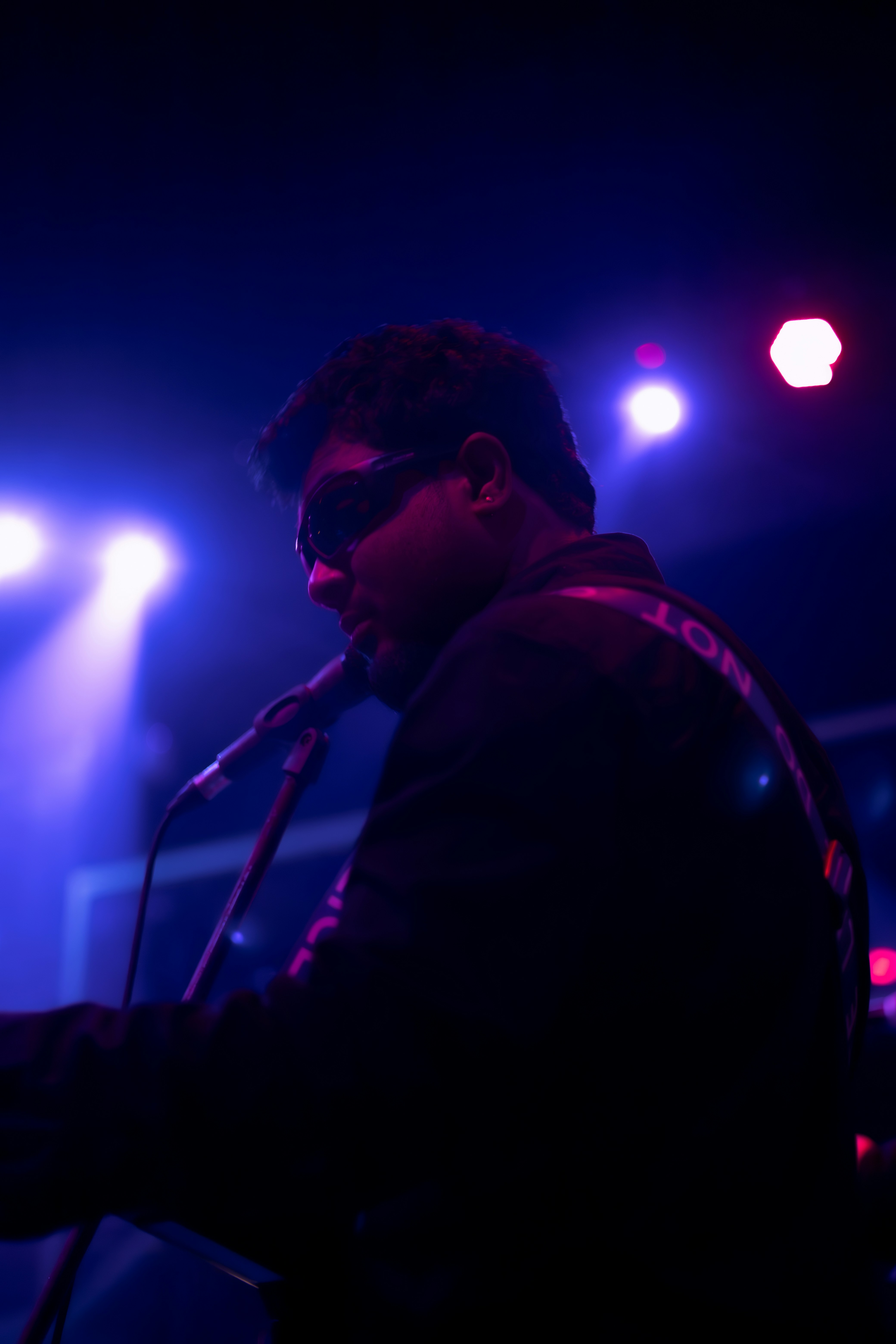 A man standing in front of a microphone on a stage