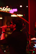 A man singing into a microphone in a dark room