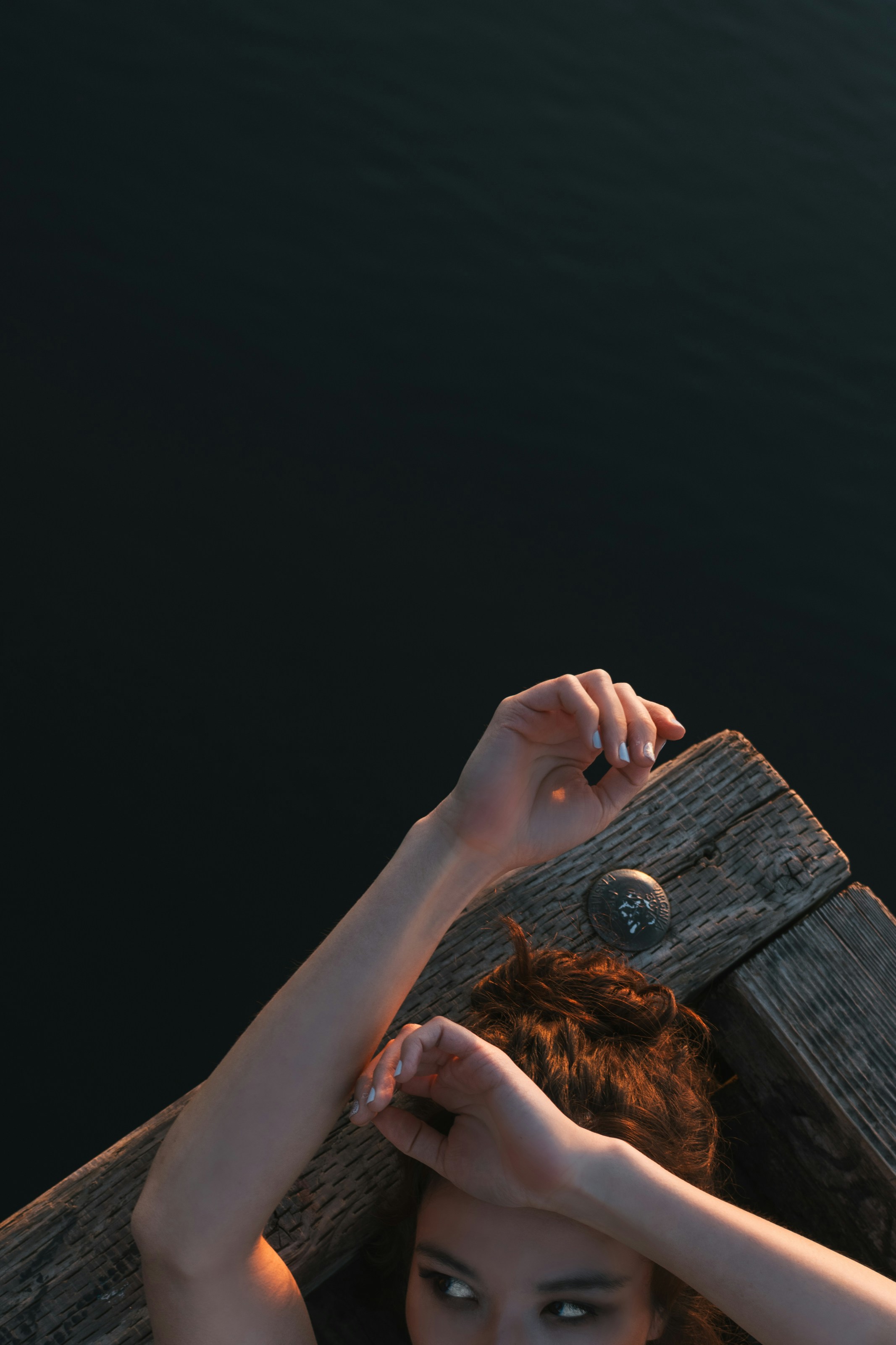 A woman holding a wooden plank over her head