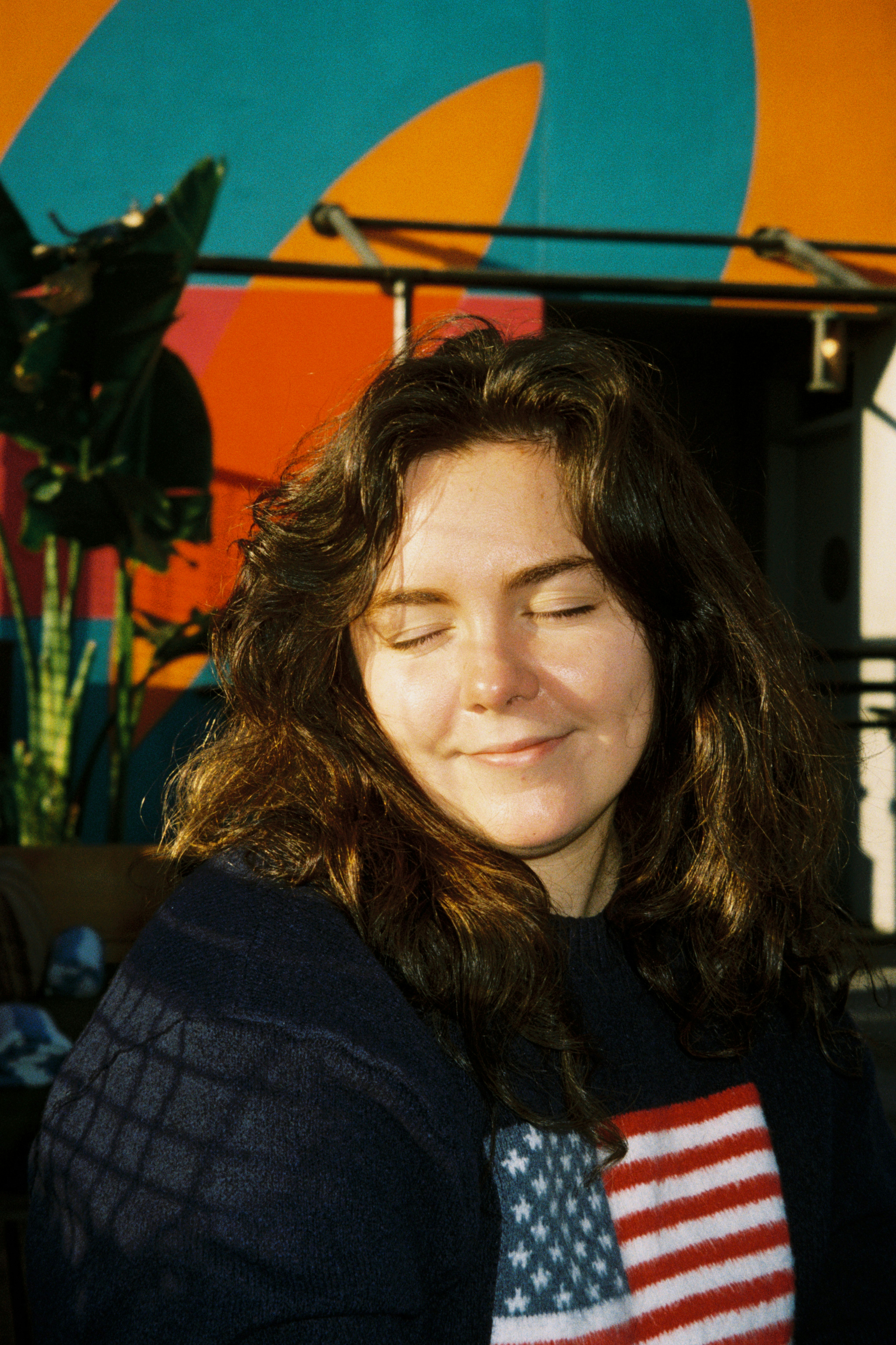 A woman with long hair and an american flag shirt