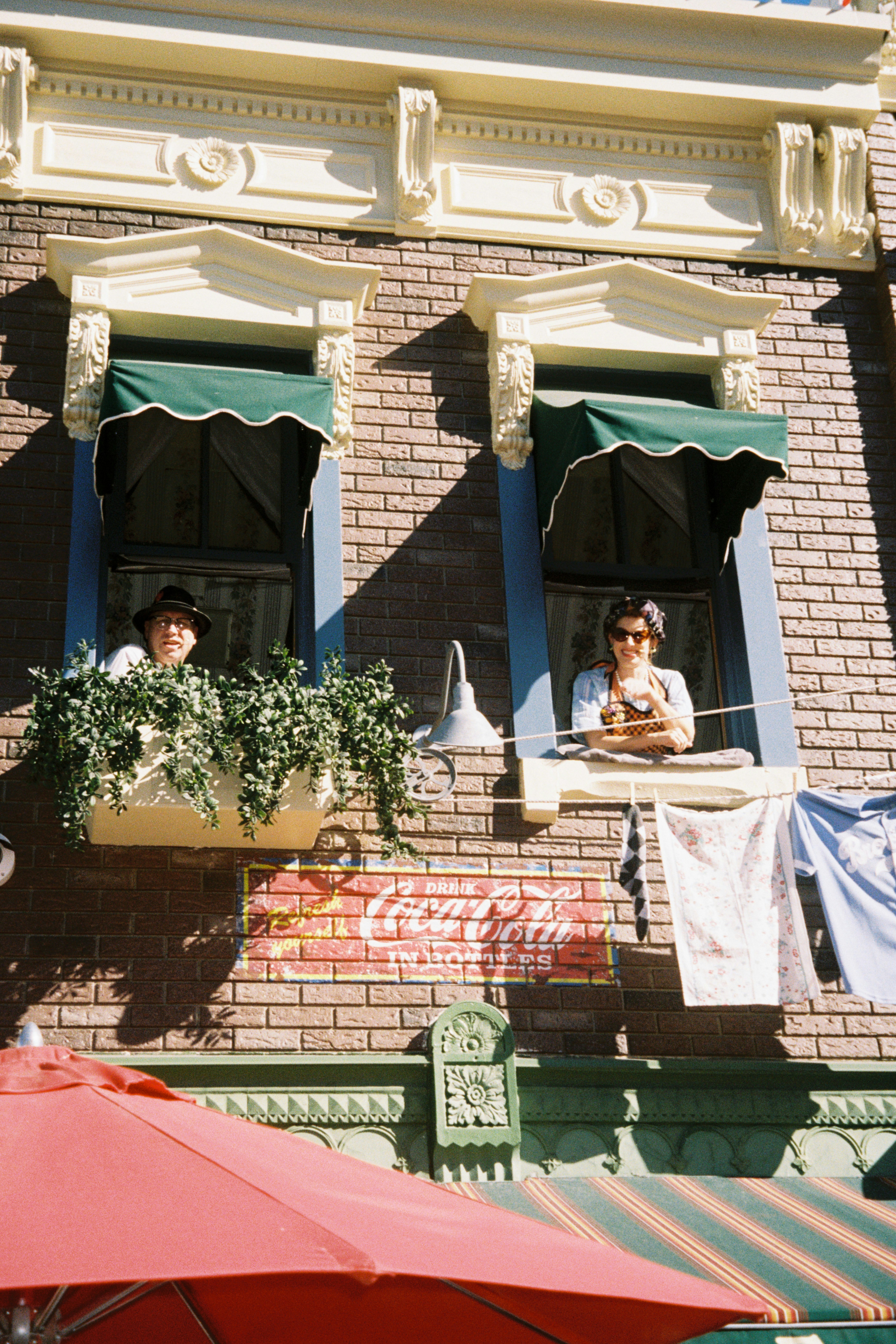 A couple of people that are sitting in a window
