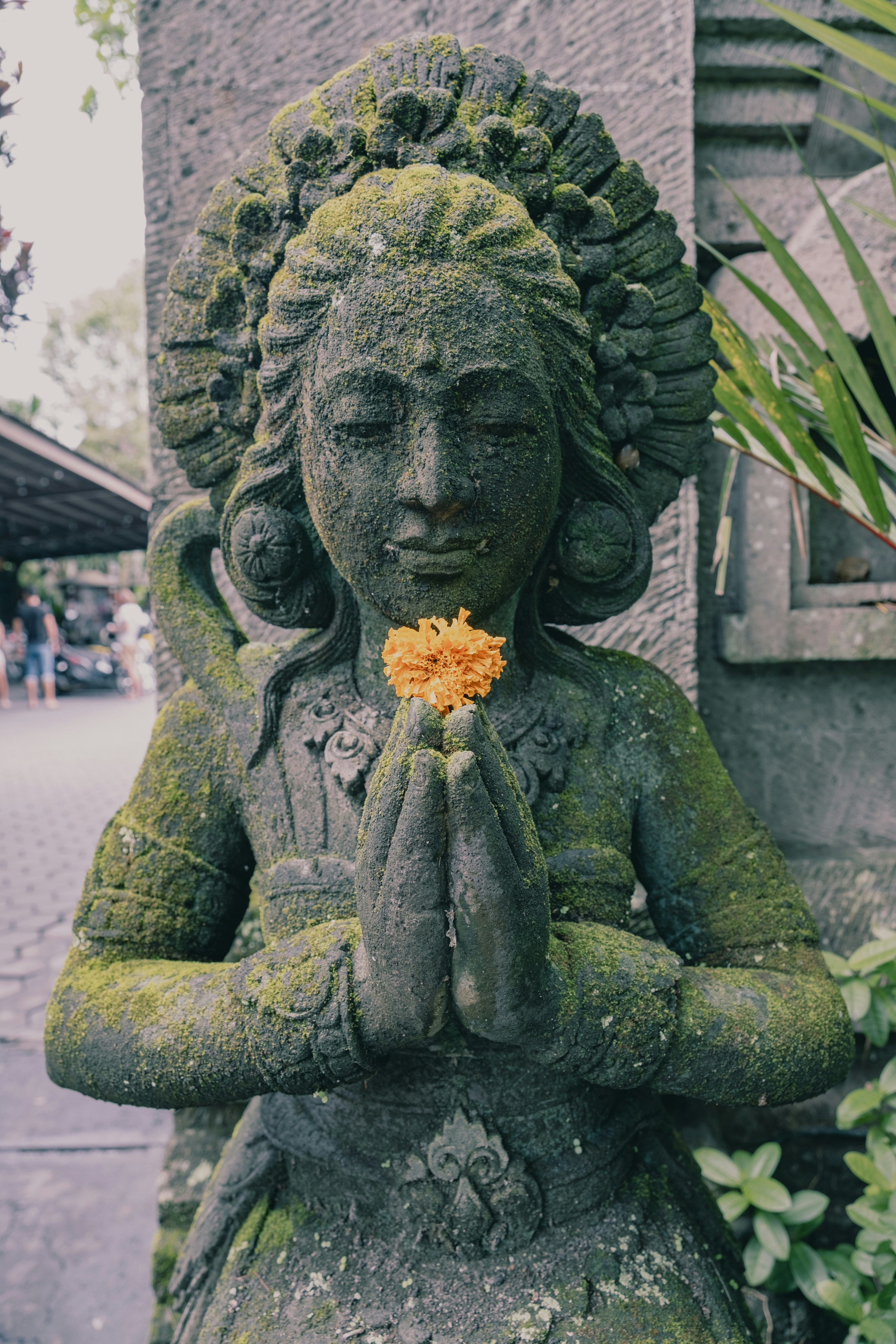 A statue of a woman with a flower in her hand