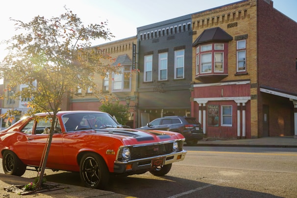 A red car parked on the side of the road
