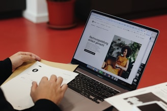 A person sitting at a table with a laptop
