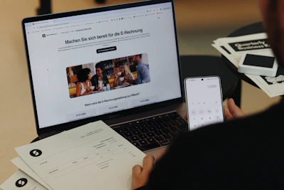 A man sitting in front of a laptop computer