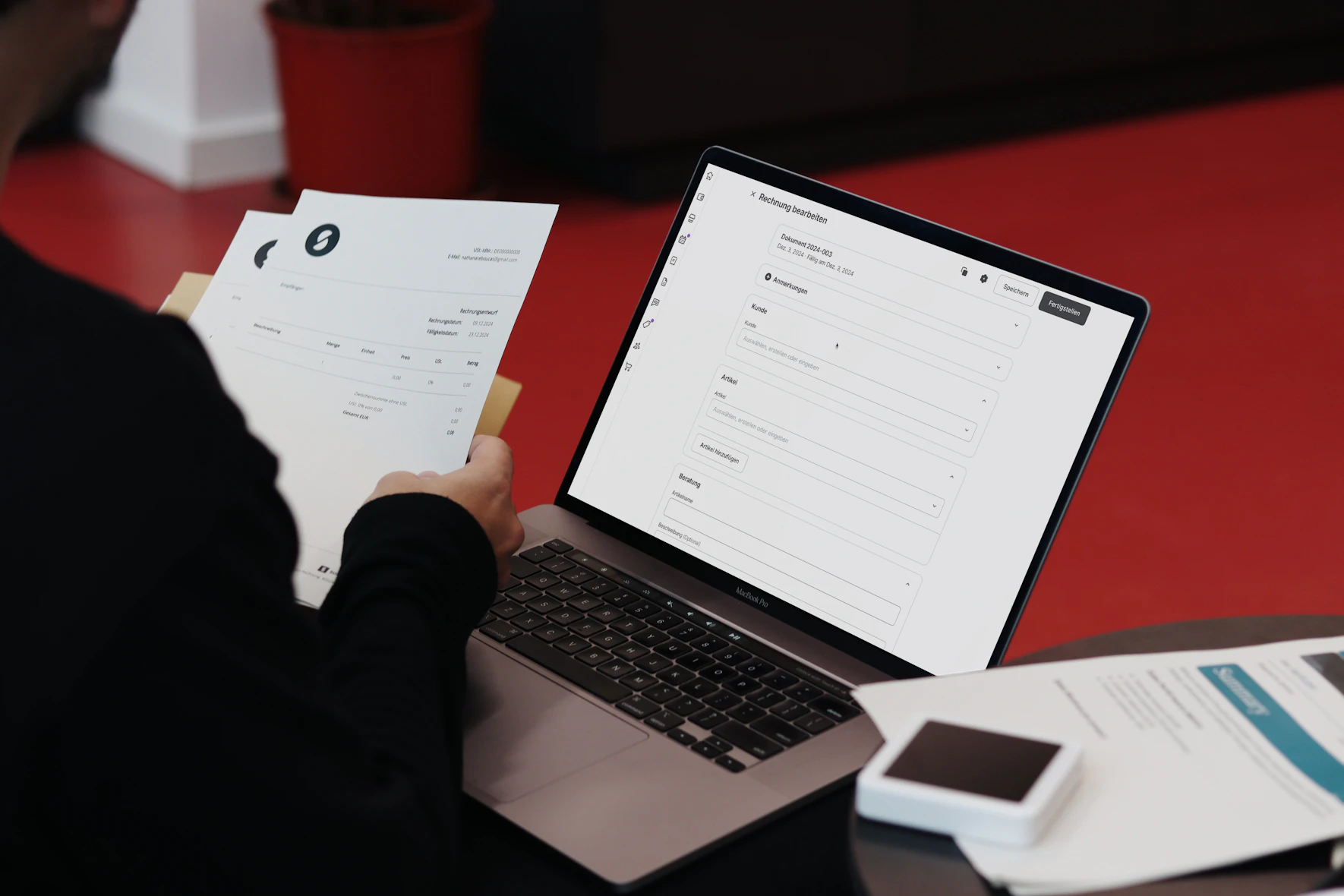 A business owner reviewing invoices at a desk