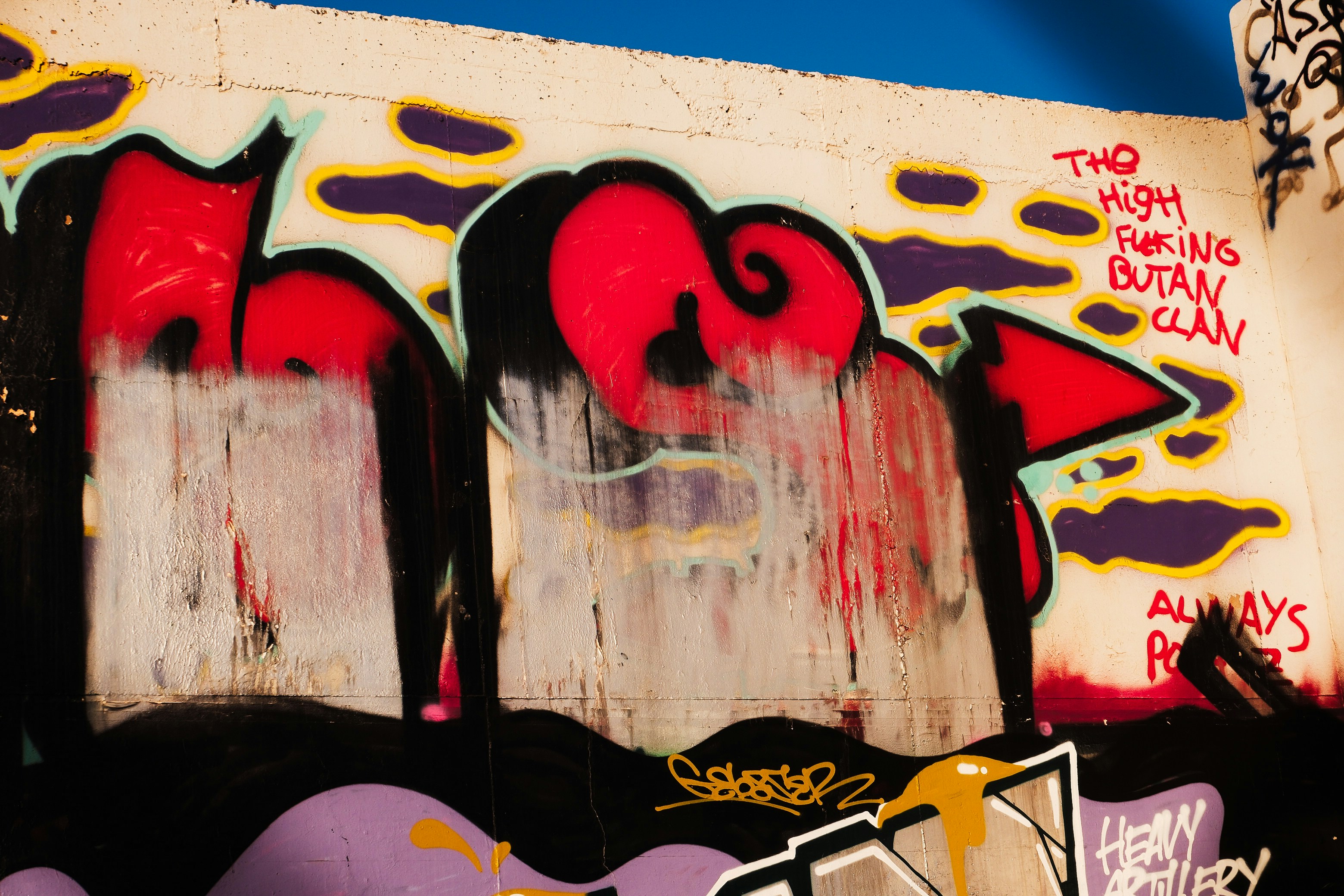 Dynamic graffiti featuring bold red, black, and purple accents