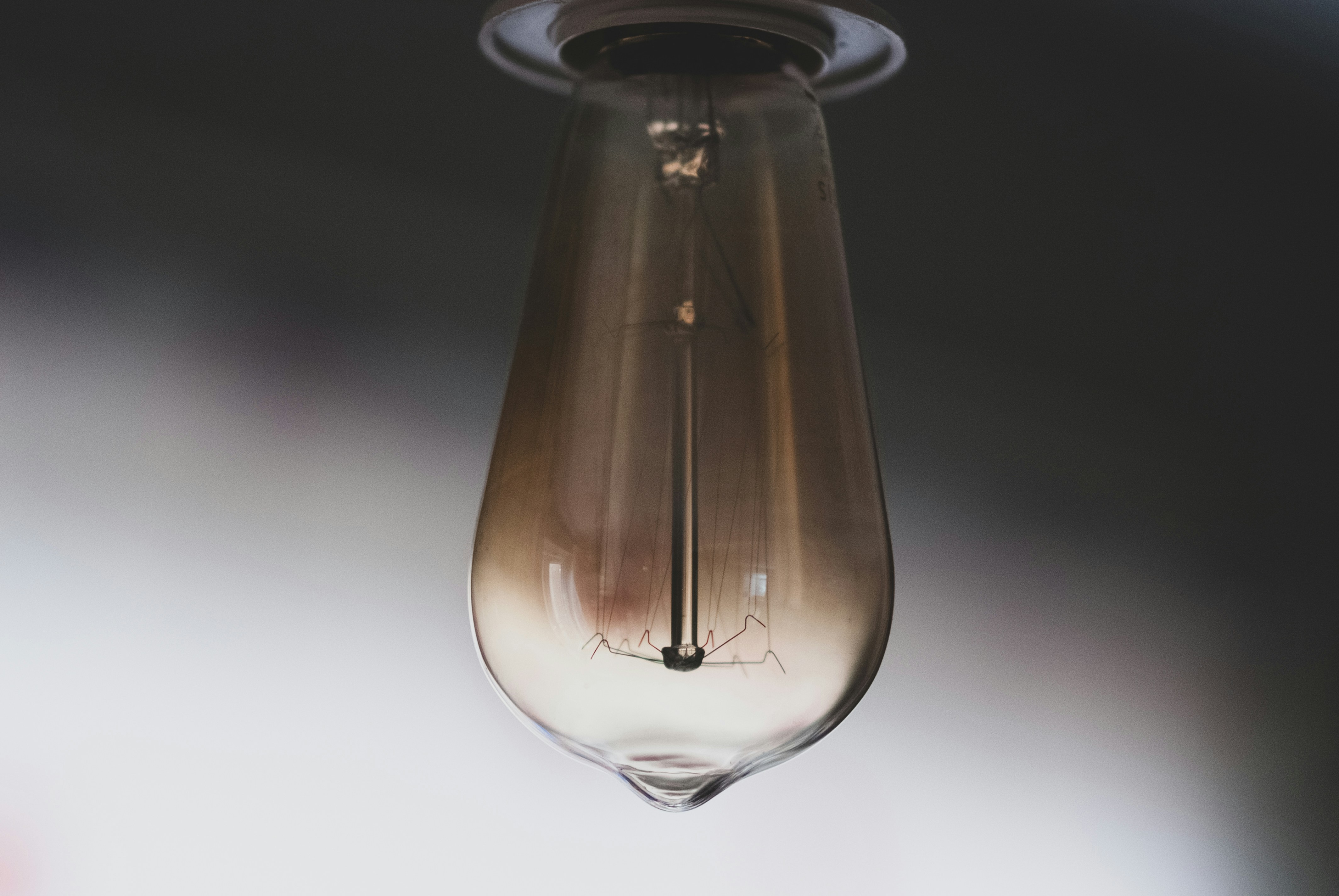A close up of a light bulb hanging from a ceiling