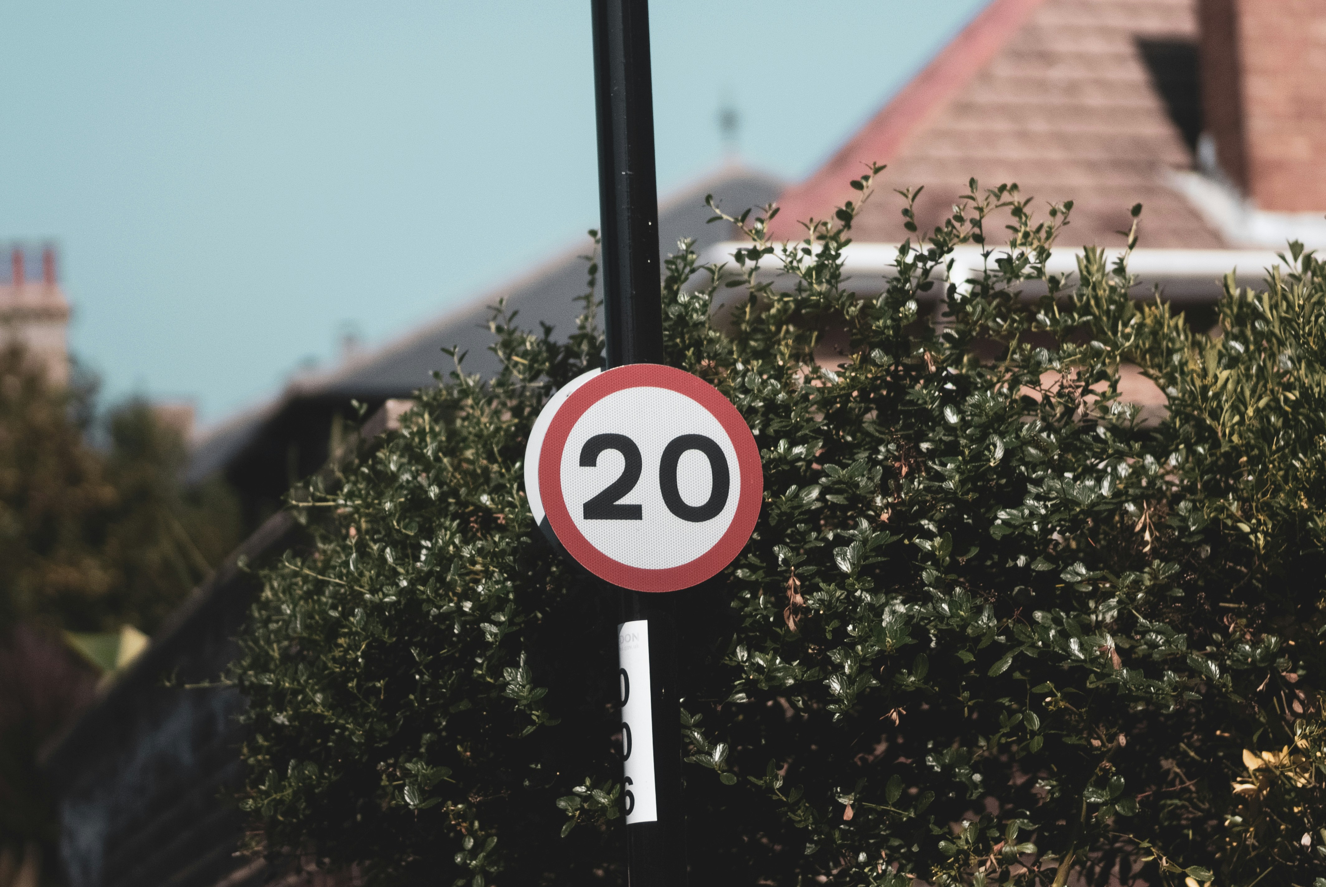 A red and white sign sitting on the side of a road