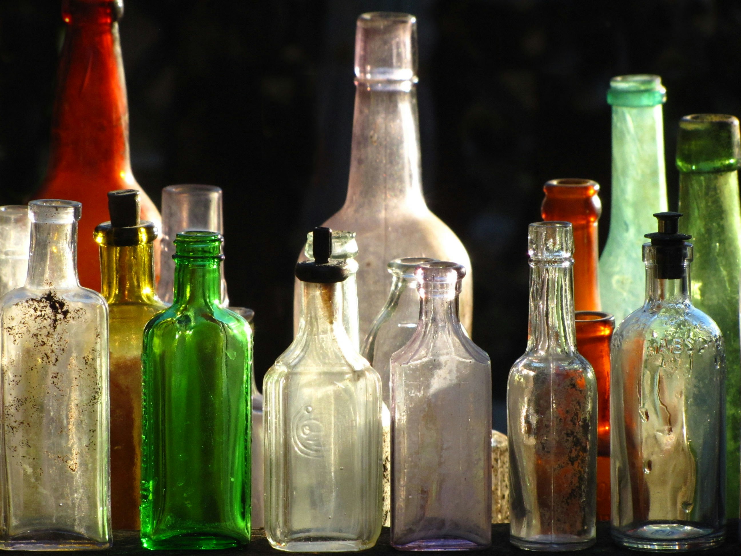 A group of bottles sitting on top of a table photo – Free Glass Image ...