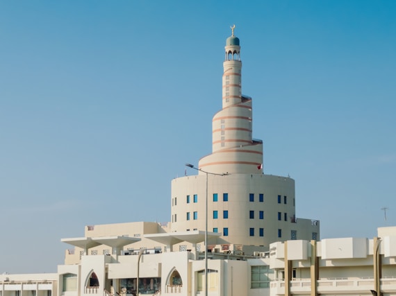 A tall white building with a clock on it's side
