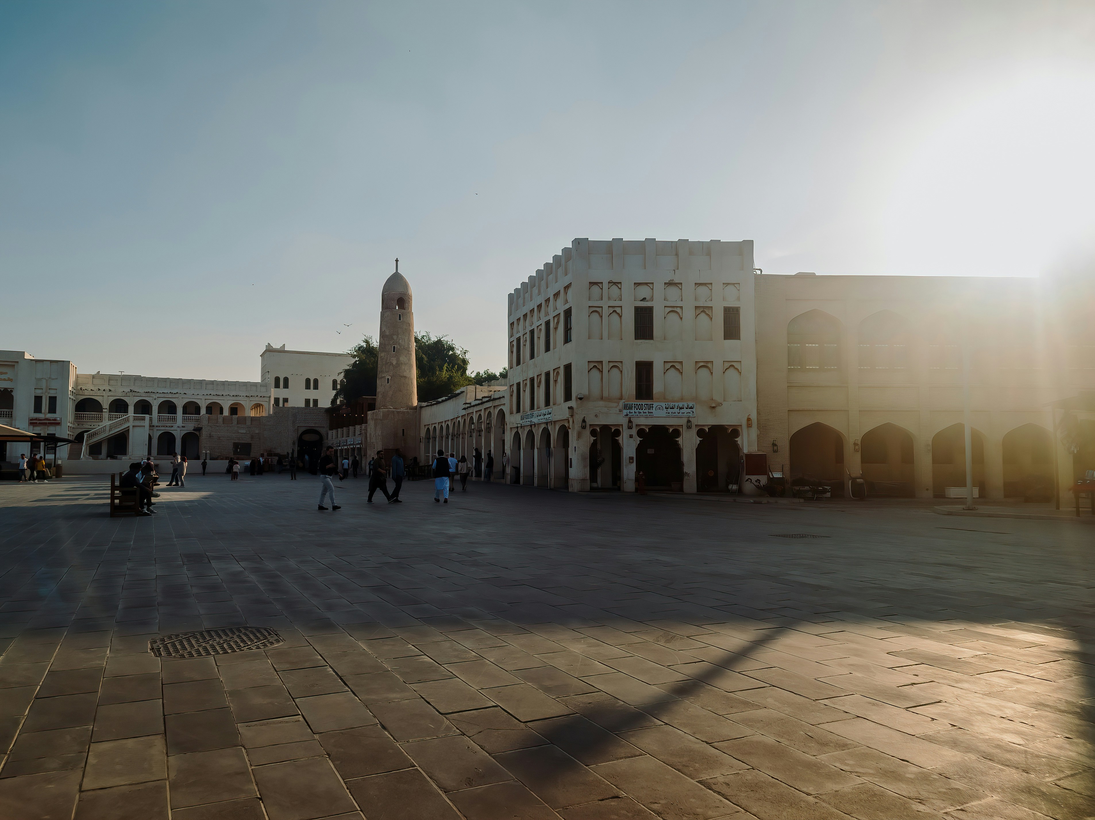 The sun shines brightly on a city square photo – Free Doha Image on ...