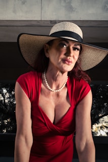 A woman in a red dress and a hat
