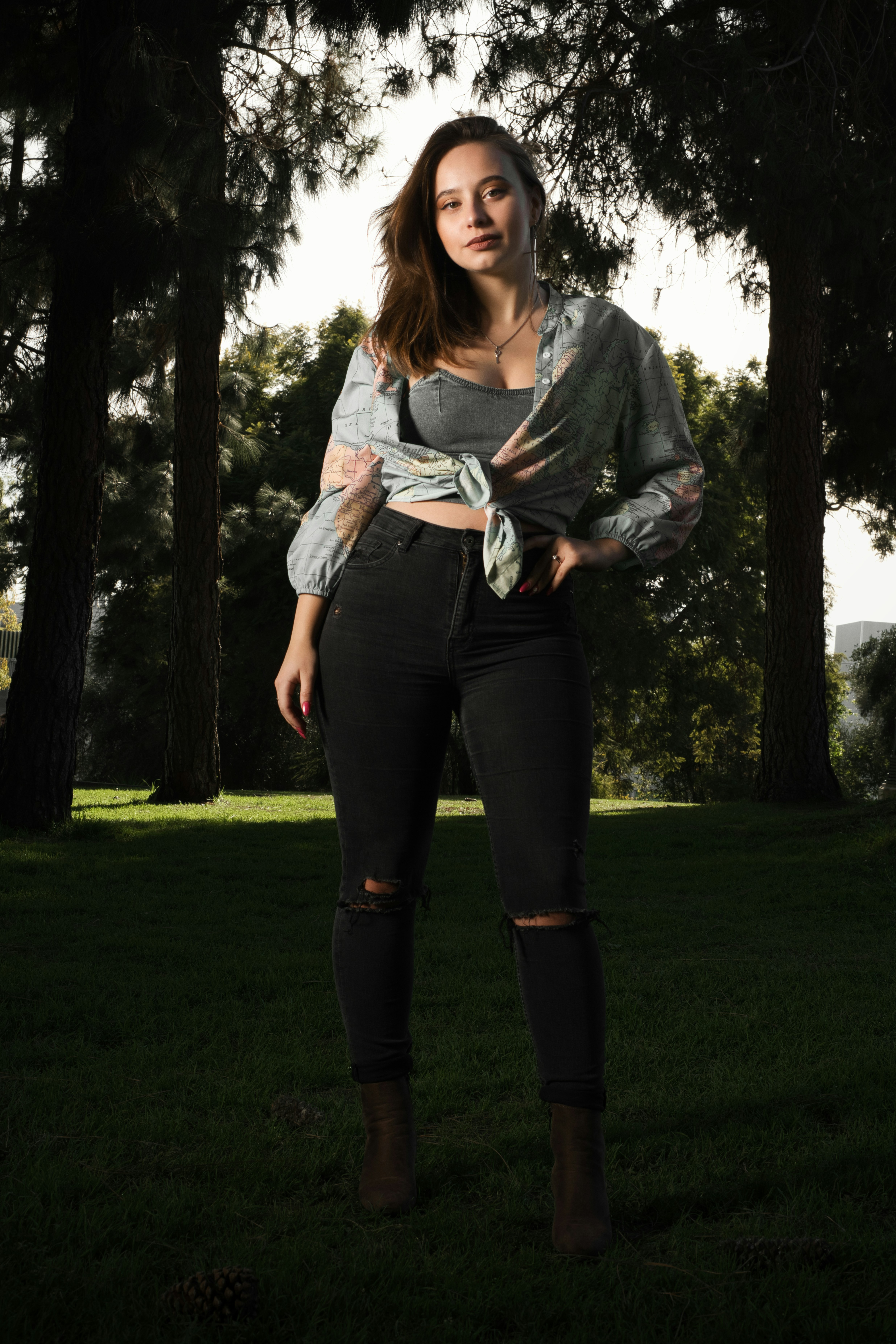 A woman standing in the grass with her hands on her hips photo – Free ...