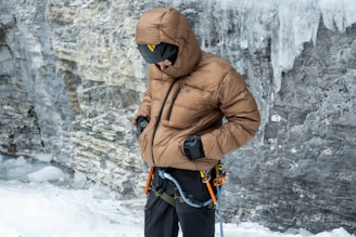 A man standing in front of a frozen waterfall