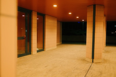 An empty room with a few doors and windows