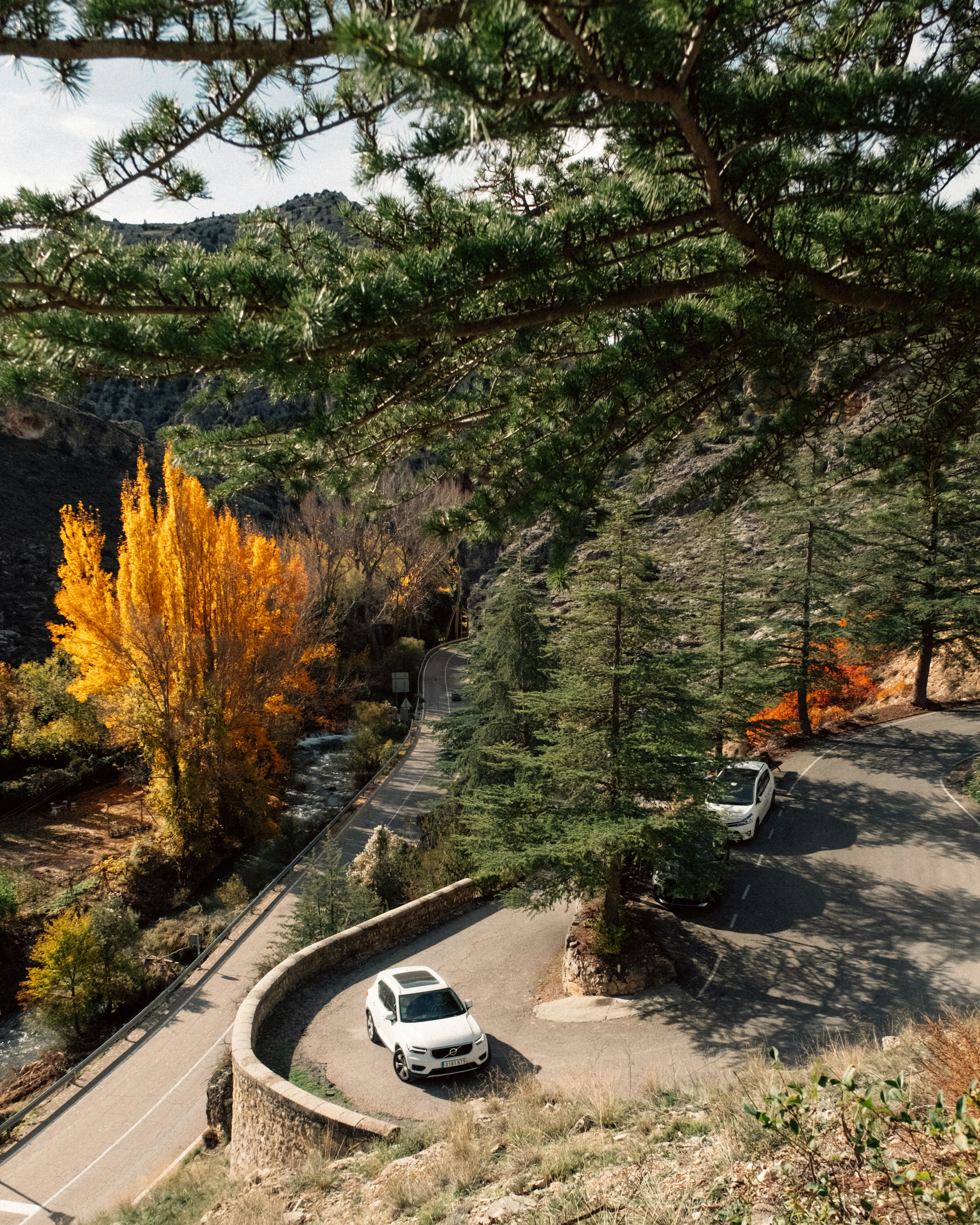 A white car driving down a winding road