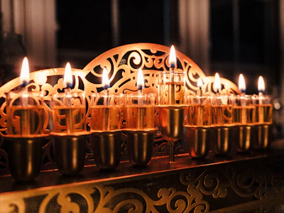 A row of lit candles sitting on top of a table