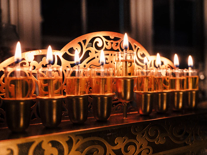 Traditional olive oil Hanukkah menorah with glowing flames