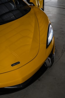A yellow sports car parked in a garage