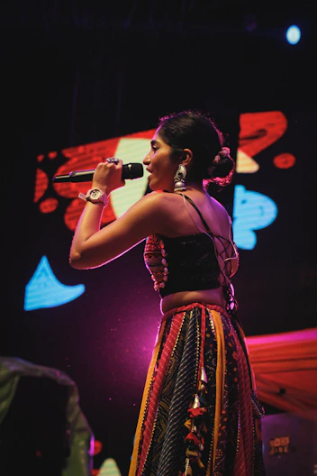 A woman standing on a stage holding a microphone