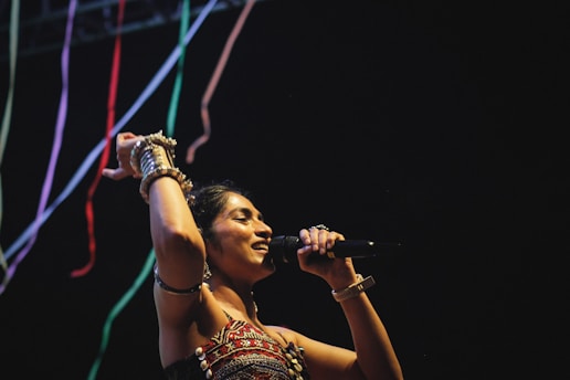A woman in a dress holding a microphone