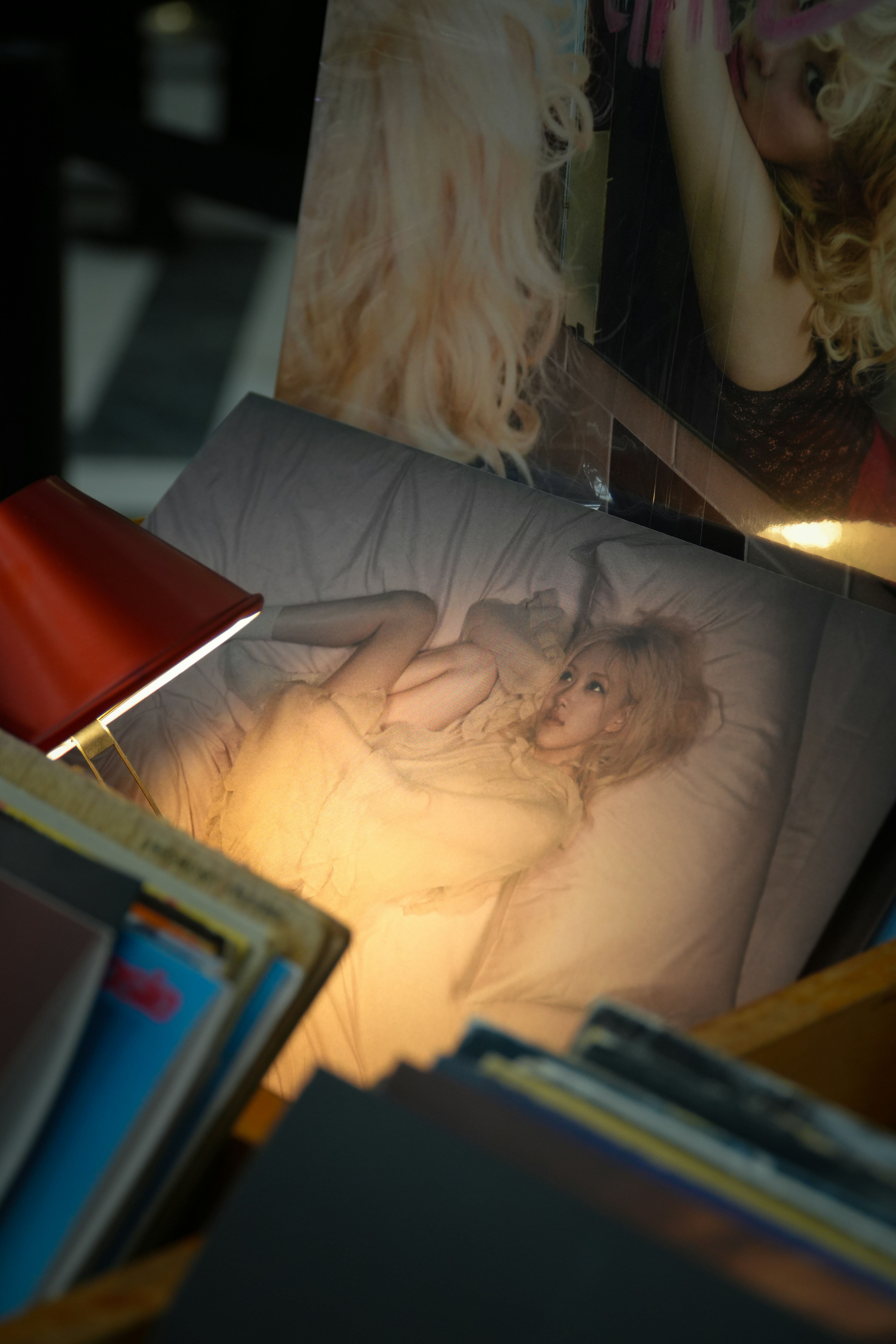 A table topped with pictures and a lamp