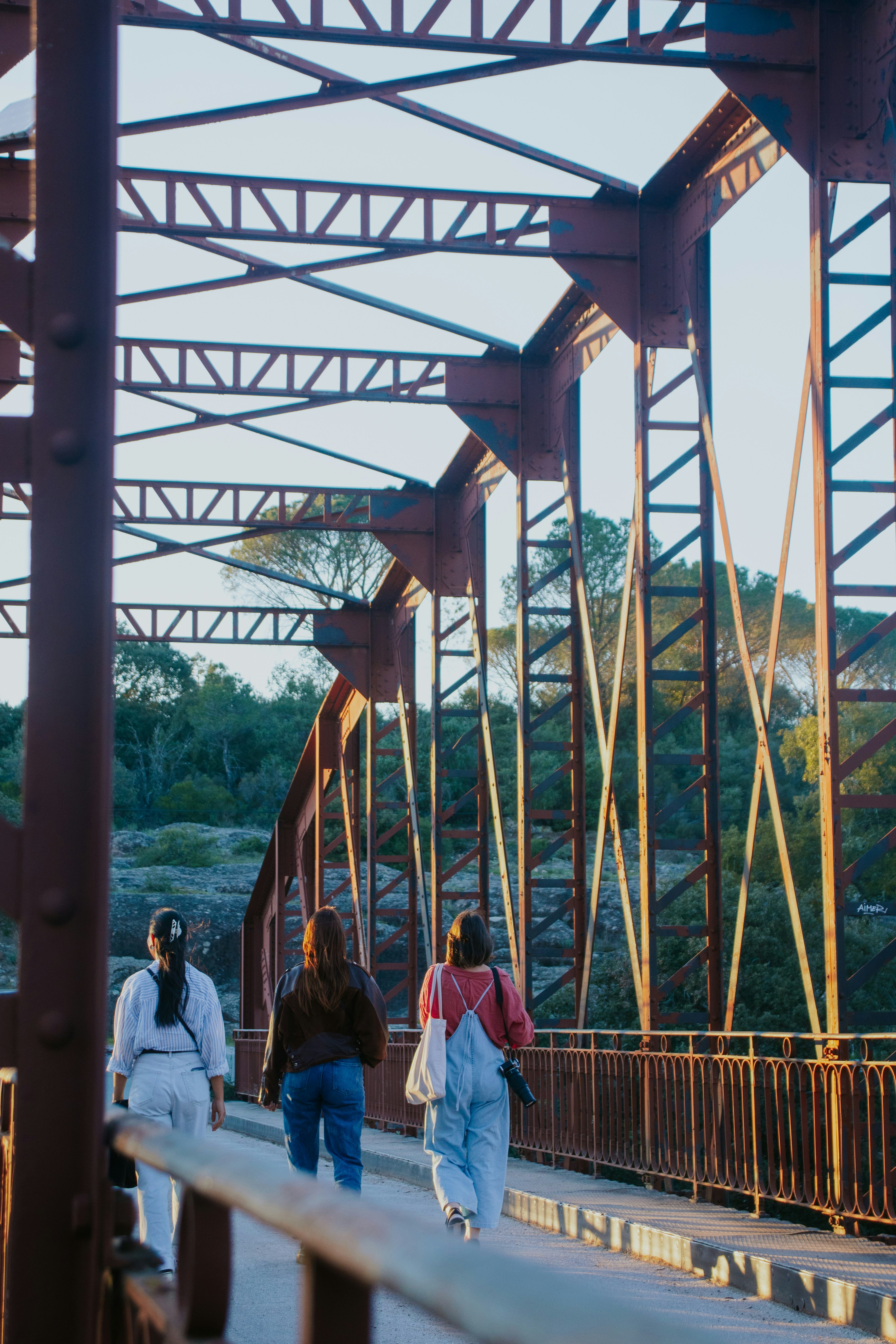 A group of people walking across a bridge