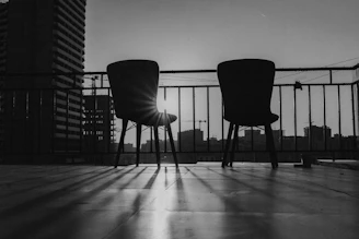 Two chairs sitting on top of a wooden floor