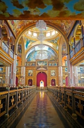 A painting of a large building with a chandelier hanging from the ceiling