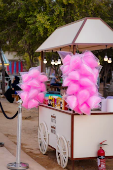 A small cart with pink bows on top of it