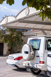 A couple of white cars parked next to each other