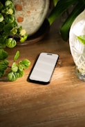 A cell phone sitting on top of a wooden table