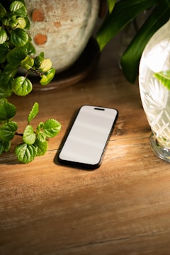 A cell phone sitting on top of a wooden table