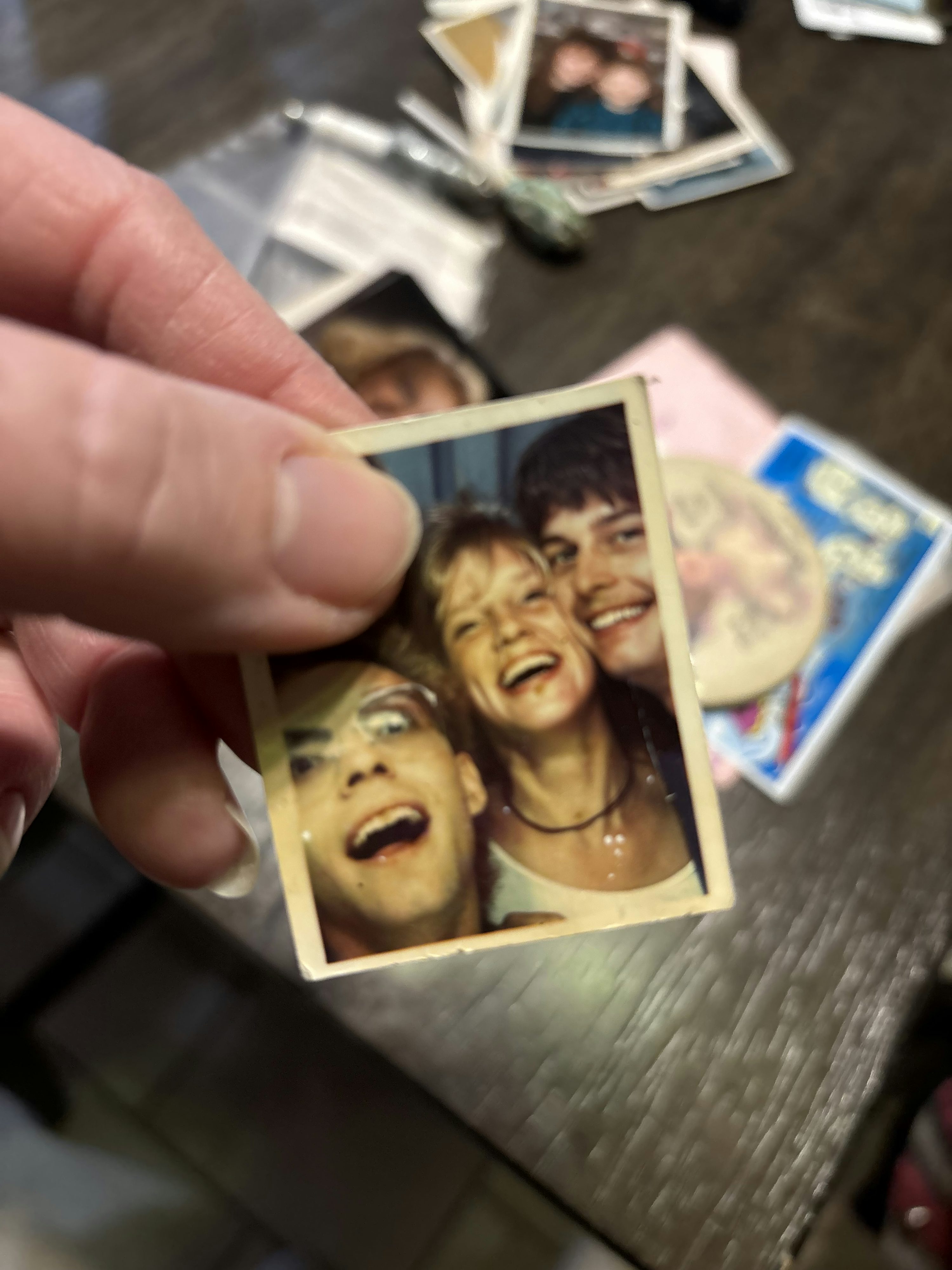 A person holding a picture of a group of people