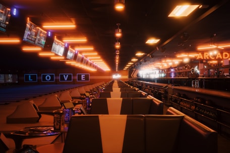 A dimly lit train station with rows of seats