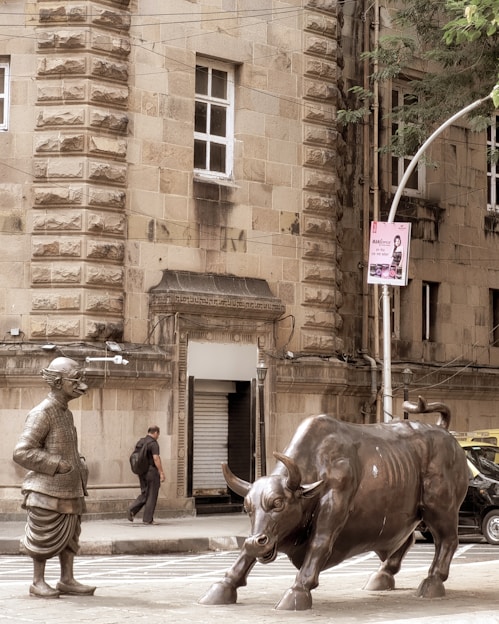A statue of a man standing next to a bull