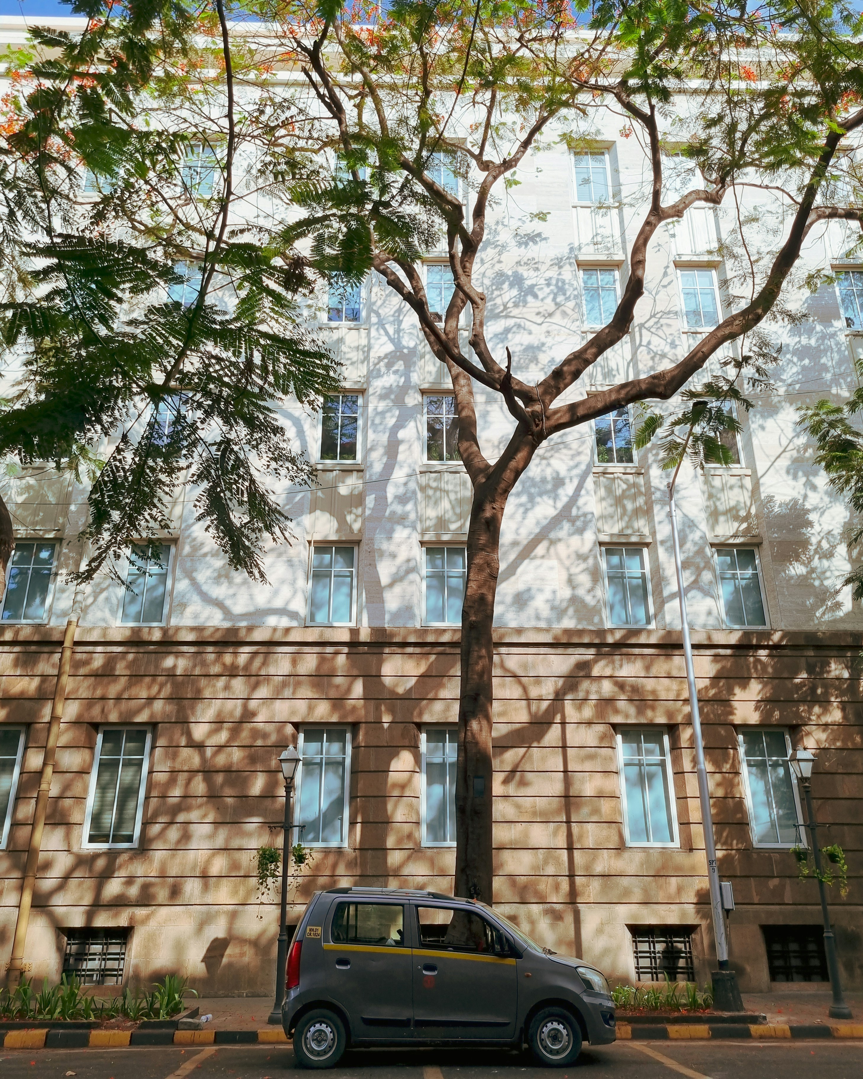 A car parked in front of a tall building photo – Free Fort Image on ...
