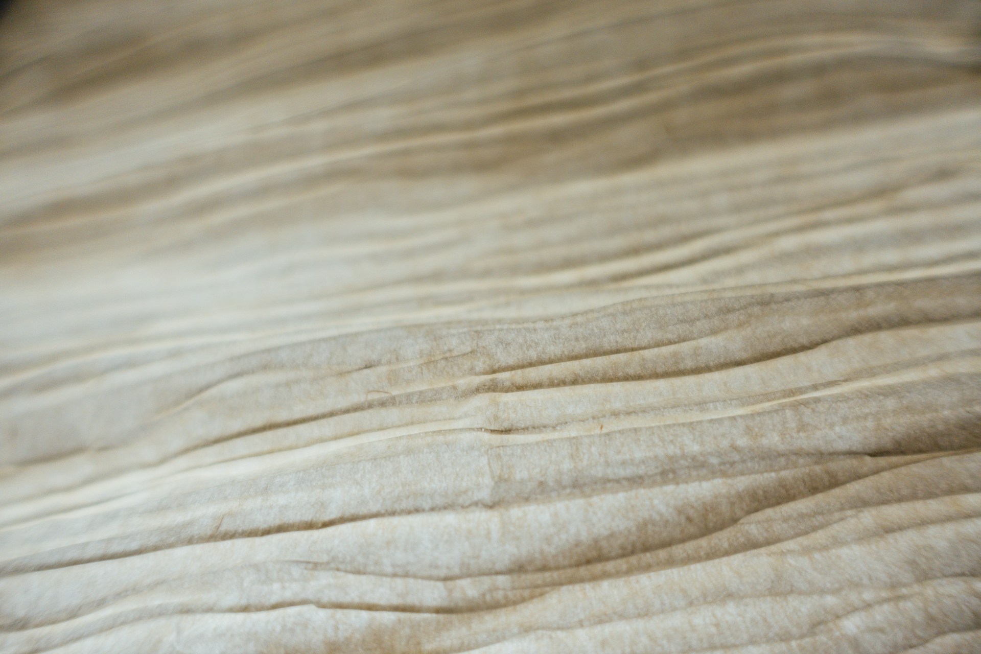 A close up of a bed with white sheets