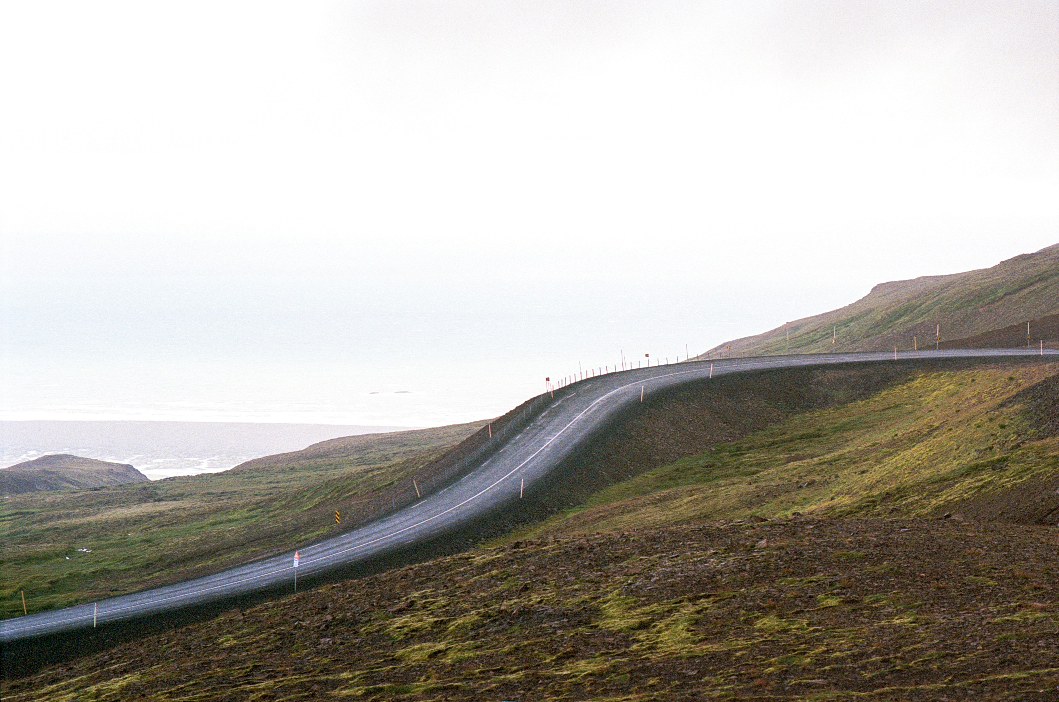 A winding road in the middle of a hilly area