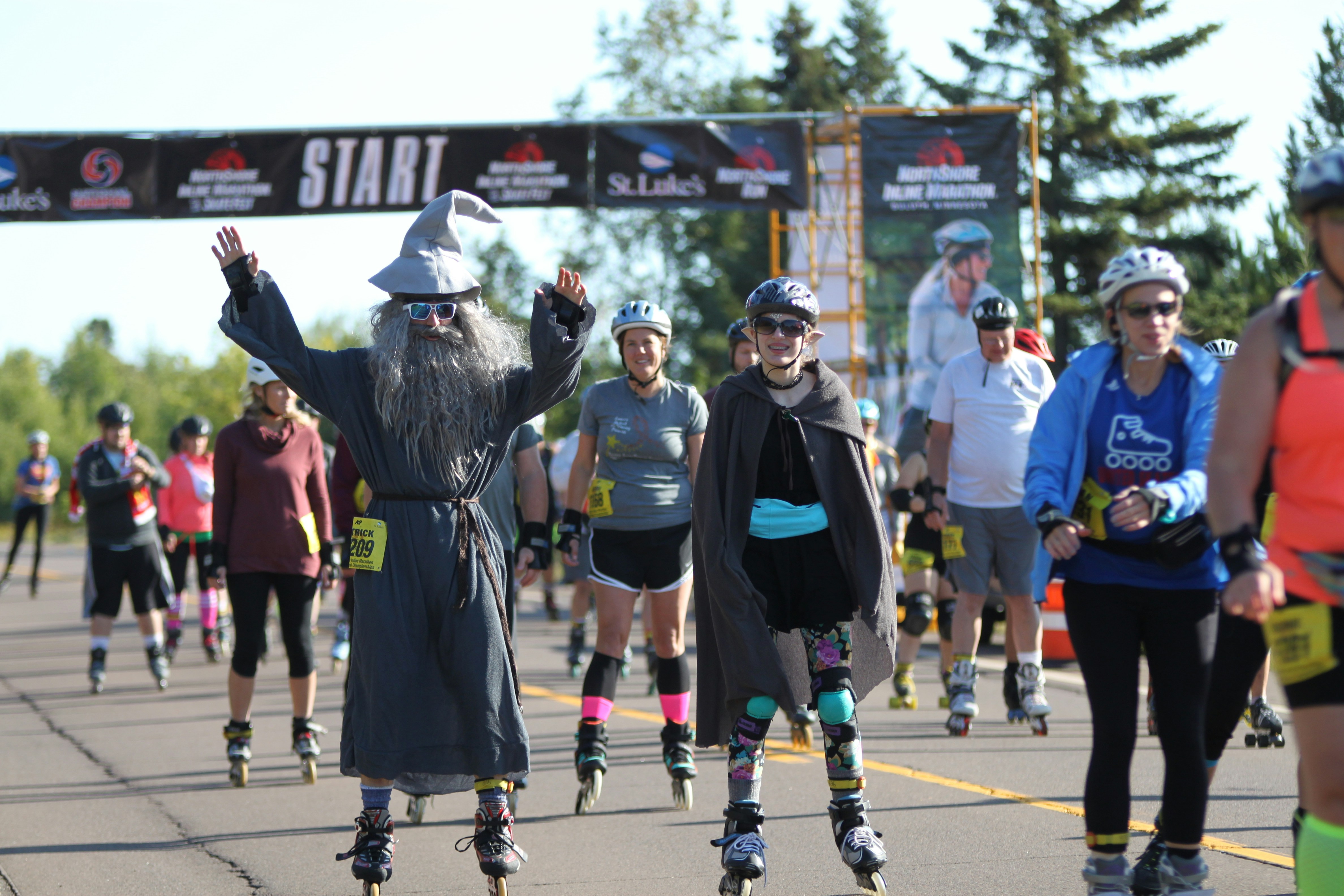 A group of people rollerblading down a street