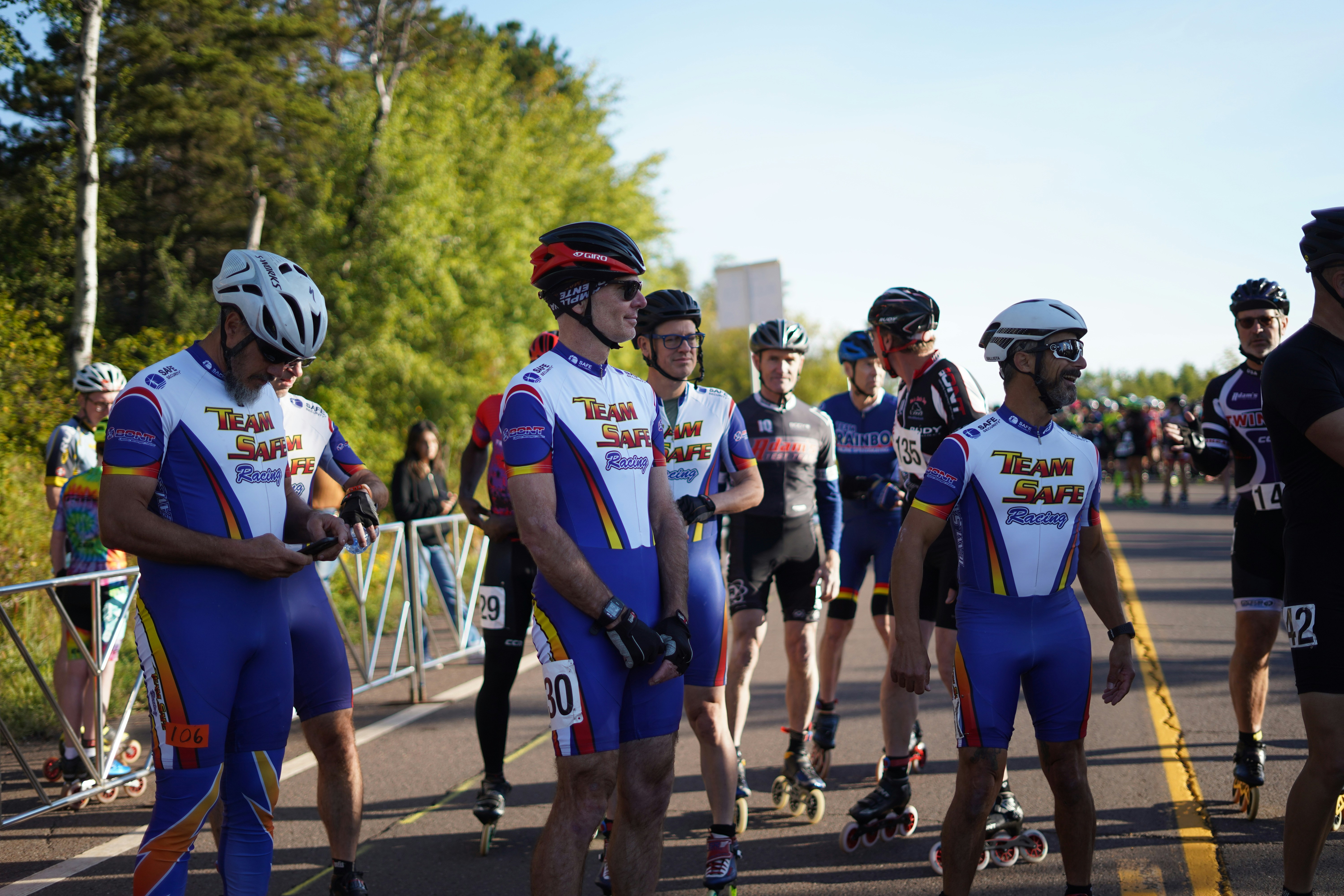 A group of people riding skateboards down a street