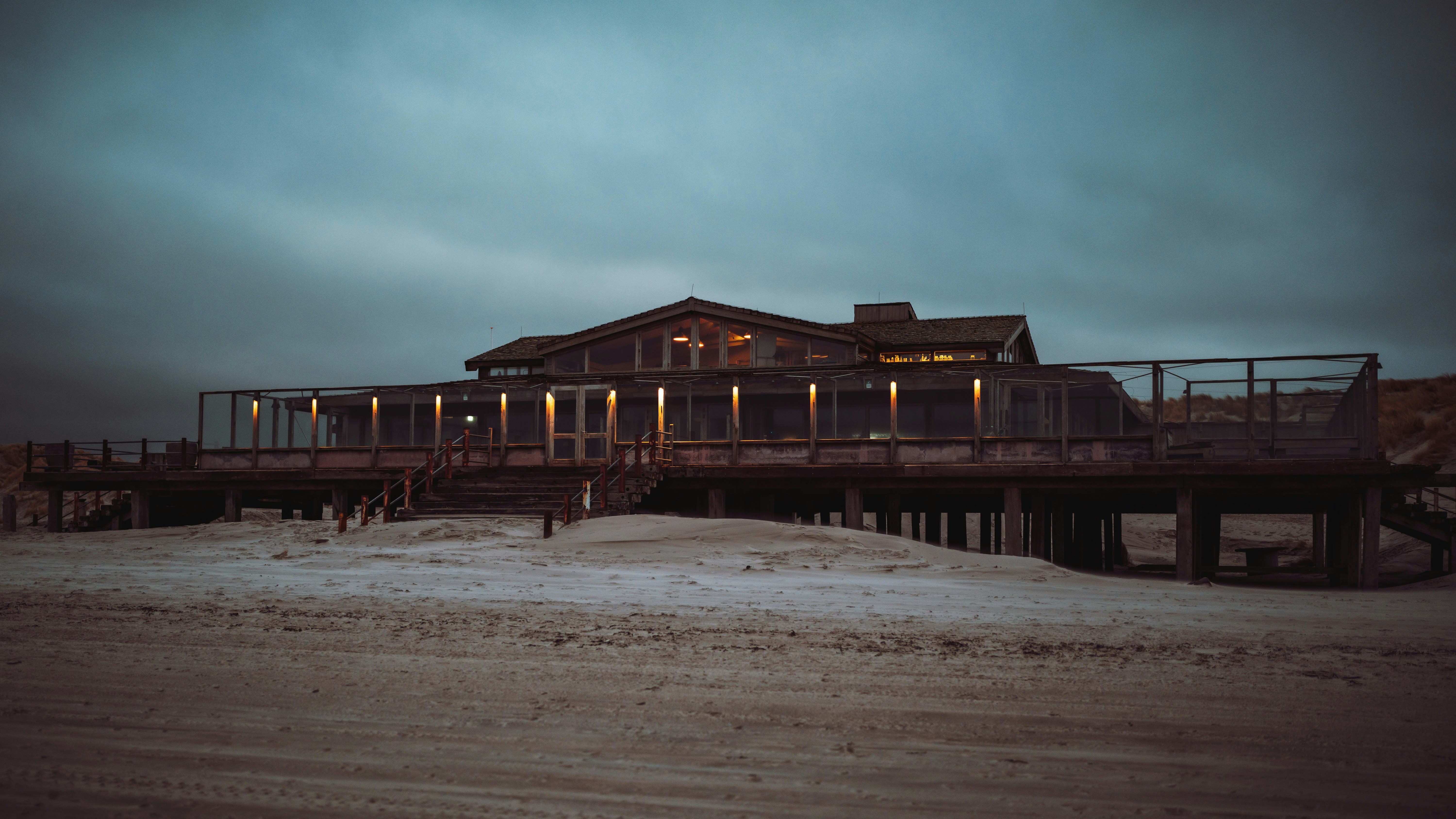 A house sitting on top of a sandy beach