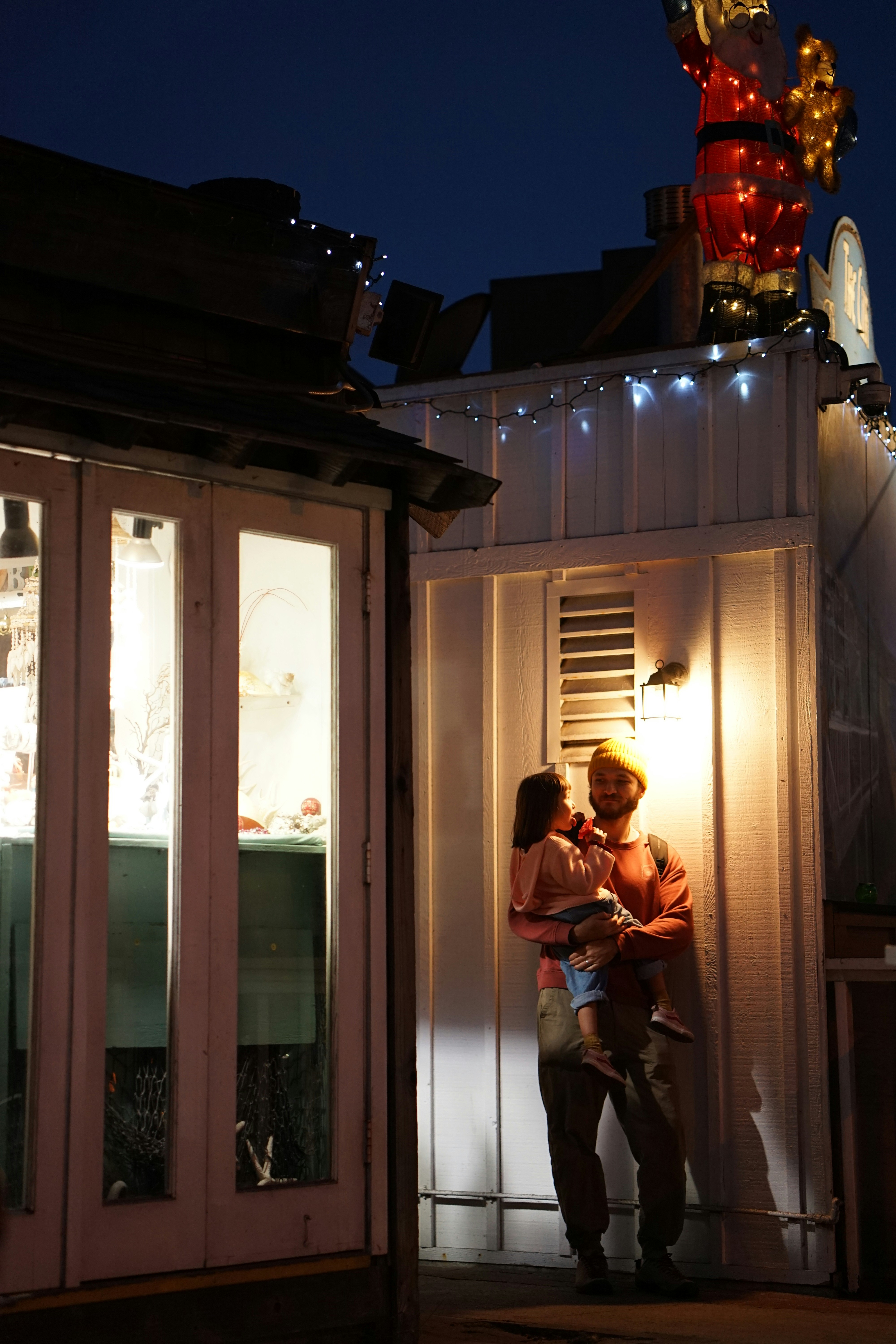 A man and a woman standing in front of a building