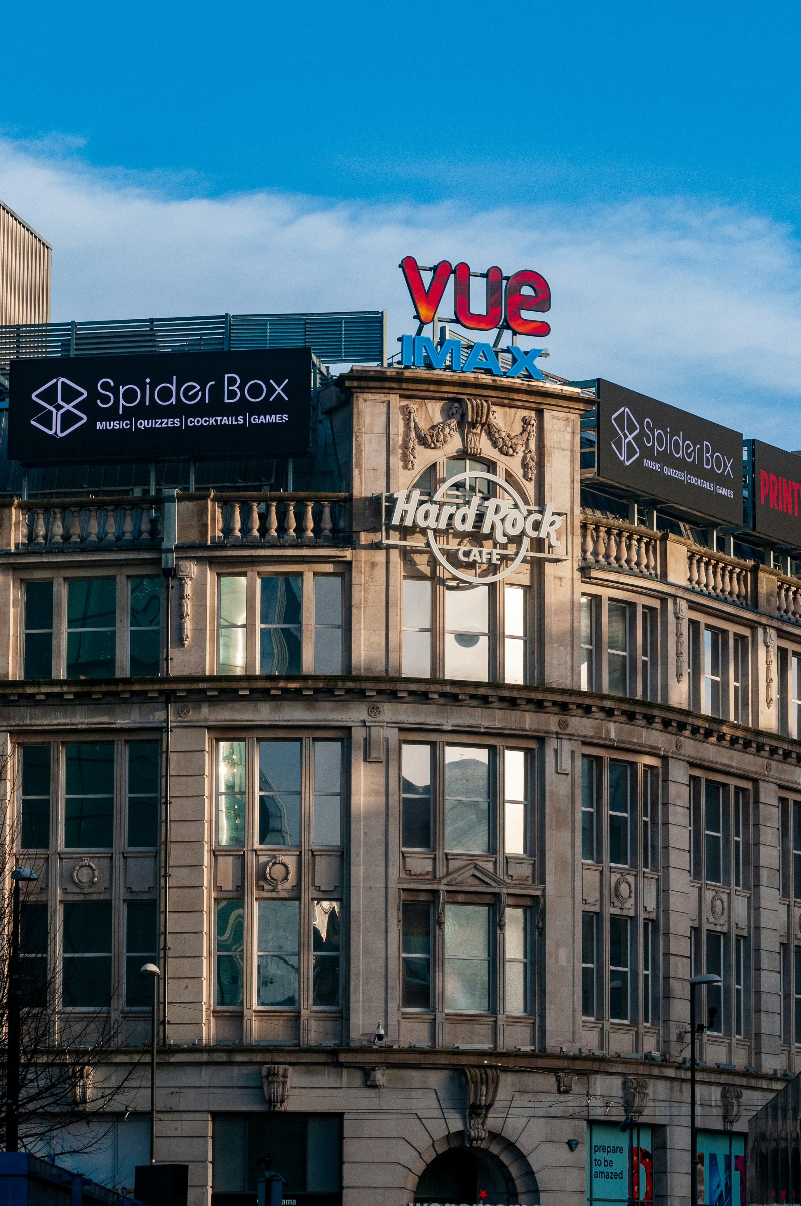 A large building with a sign on top of it photo – Free City Image on ...