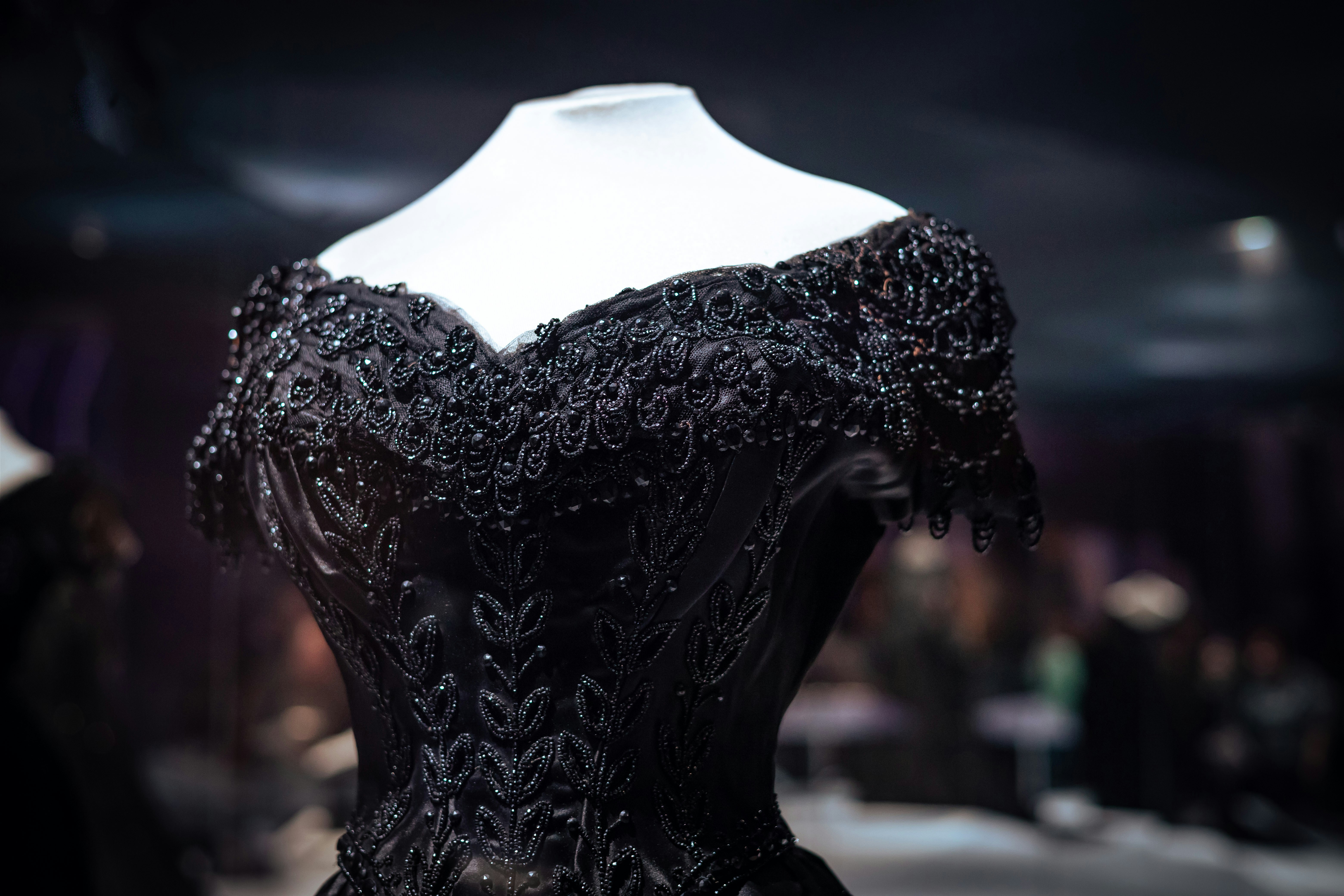 A black dress on a mannequin in a room