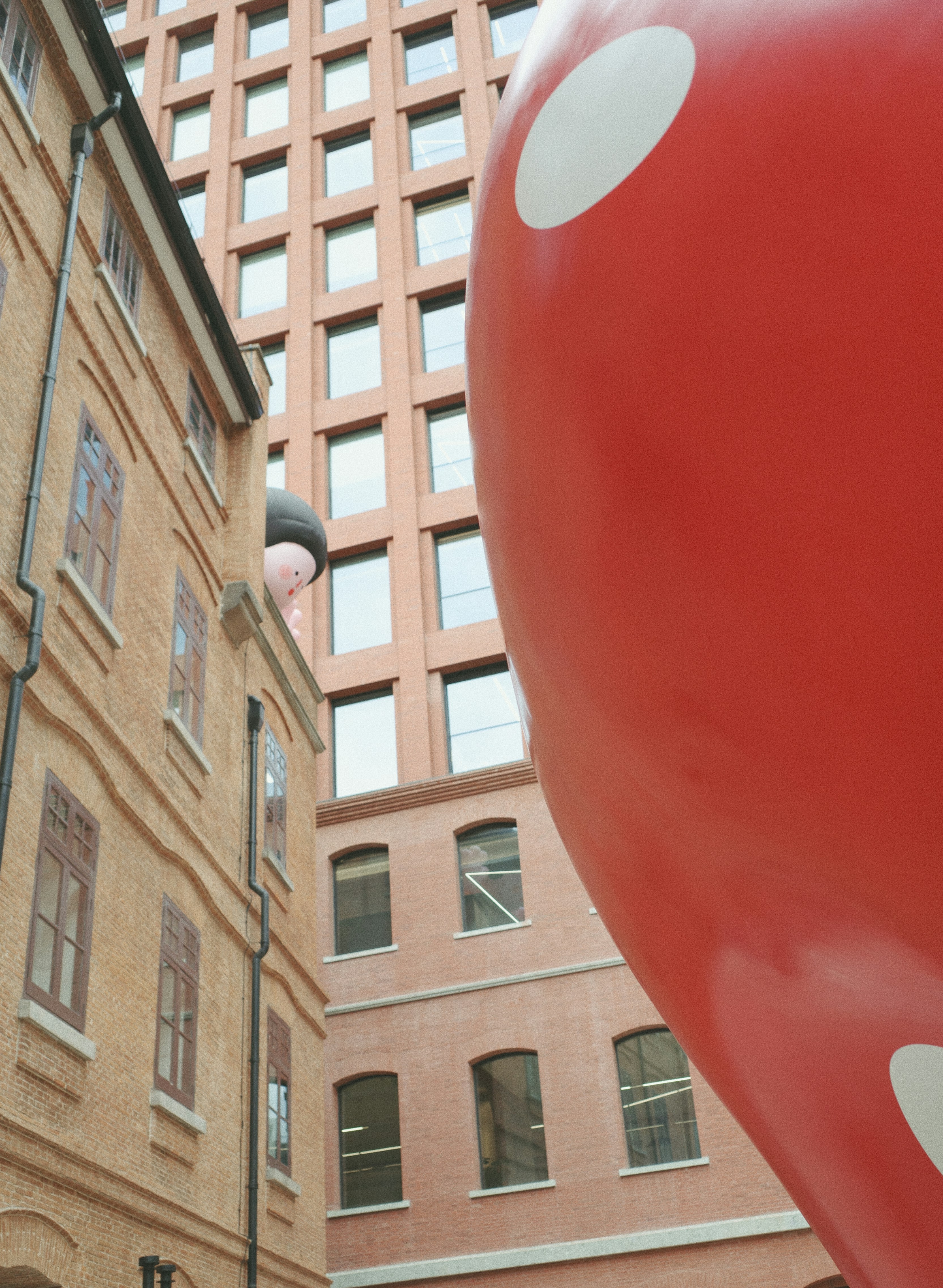 A large red balloon sitting in the middle of a street photo – Free ...